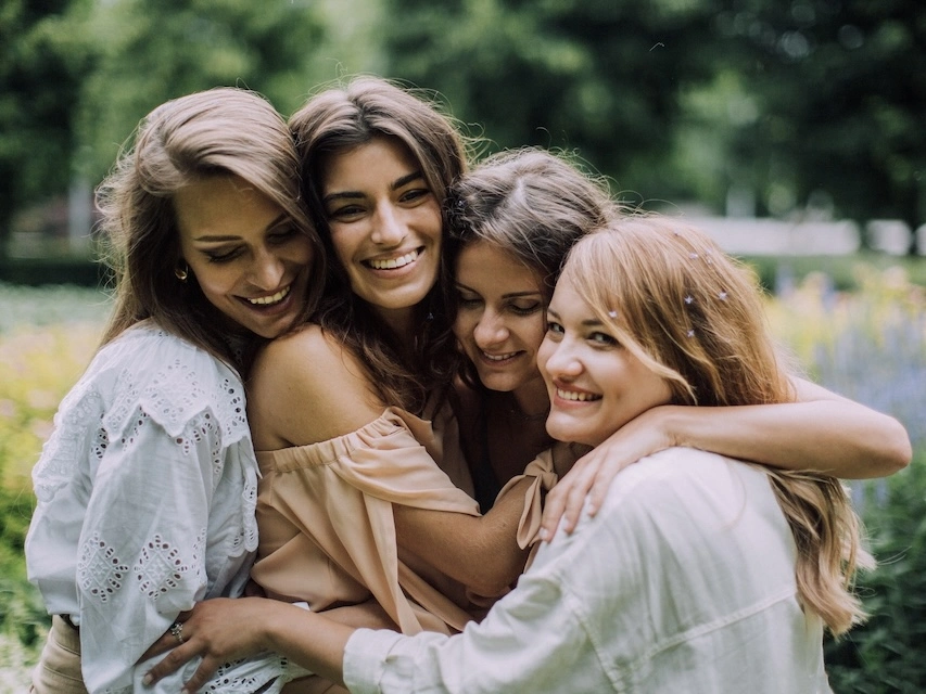 Group of women hugging. 