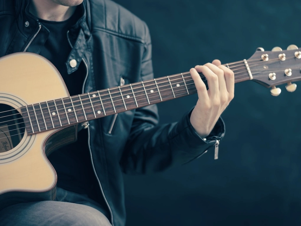 Man playing a guitar.