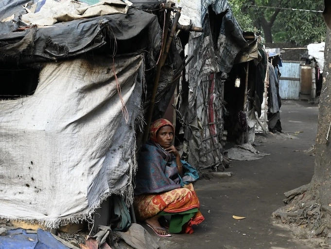 A woman sitting a slum. 
