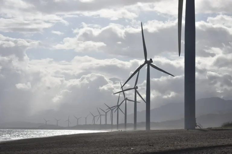 A row of wind turbines in a wind farm.
