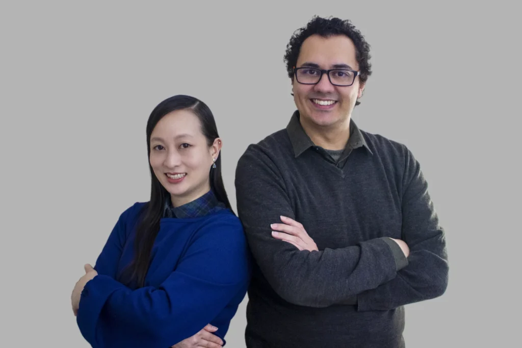A man and woman standing together, smiling.